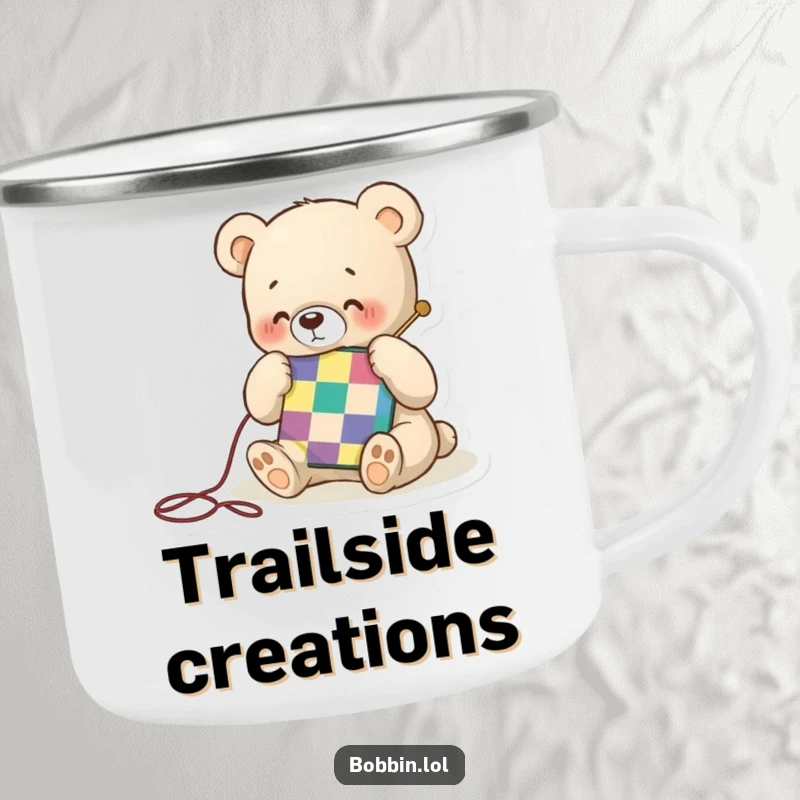 Funny camping mug with a tiny bear happily stitching a colorful quilt square, ideal for enjoying warm drinks during crafting.